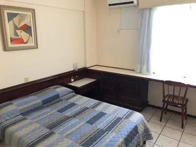 Uma cama ou camas num quarto em Hotel Residencial Itapema