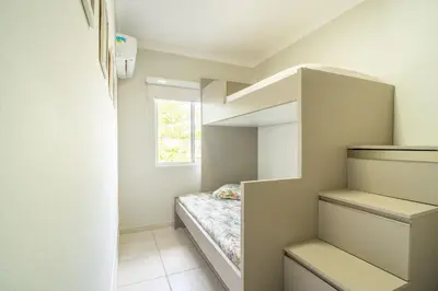 Uma cama ou camas num quarto em Frente ao mar - Residencial Guilhermina - Casa 08