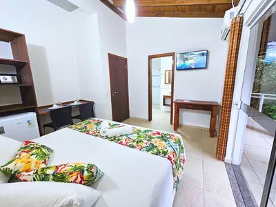Uma cama ou camas num quarto em Refúgio da Lagoinha - Centro de Bombinhas