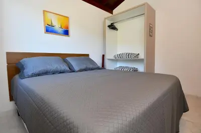 Uma cama ou camas num quarto em BANGALÔ CASA DO MAR - EXCLUSIVIDADE, CONFORTO E PRIVACIDADE.