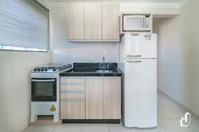A cozinha ou kitchenette de Aqui tudo contribui para felicidade e o bem-estar
