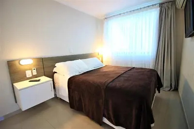 Uma cama ou camas num quarto em Bombinhas Summer Beach - Cond Apart Privados