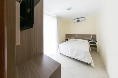Uma cama ou camas num quarto em Bombinhas Praia Apart Hotel - Unidade rua Corrupião