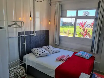 Uma cama ou camas num quarto em Espaço Container Itapema - Loft I