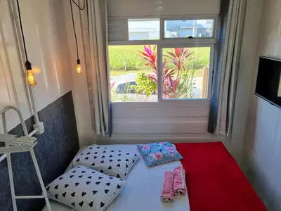 Uma cama ou camas num quarto em Espaço Container Itapema - Loft I