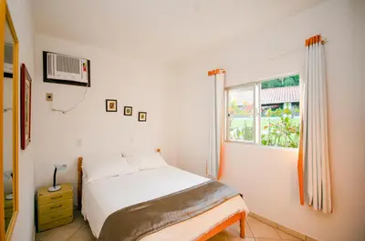 Uma cama ou camas num quarto em Pousada Canto das Pedras