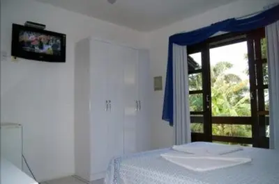 Uma cama ou camas num quarto em Pousada Guaruja