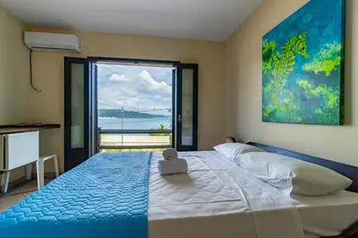 Uma cama ou camas num quarto em Pousada Caminho do Mar