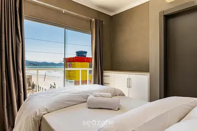 Uma cama ou camas num quarto em Duplex pé na areia com vista deslumbrante RAT001