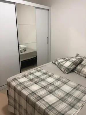 Uma cama ou camas num quarto em Apartamento praia de Palmas/SC