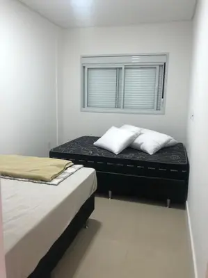 Uma cama ou camas num quarto em Apartamento praia de Palmas/SC