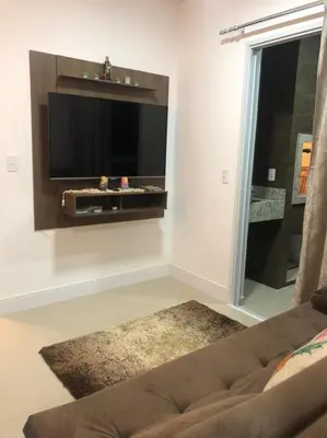 Uma televisão e/ou sistema de entretenimento em Apartamento praia de Palmas/SC