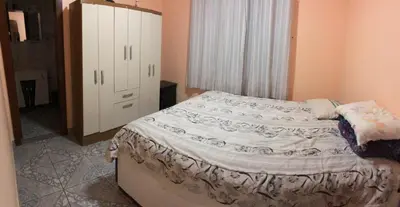 Uma cama ou camas num quarto em Residencial Marcelino