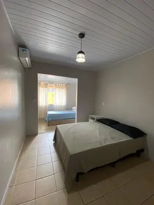 Uma cama ou camas num quarto em Casa entre dois mares - Casa Laranja