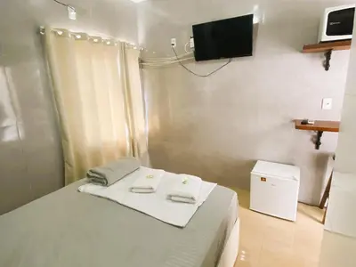 Uma televisão e/ou sistema de entretenimento em CASA OLINDA - XXEstudio e SuitesXX wifi Ar split e Piscina YY