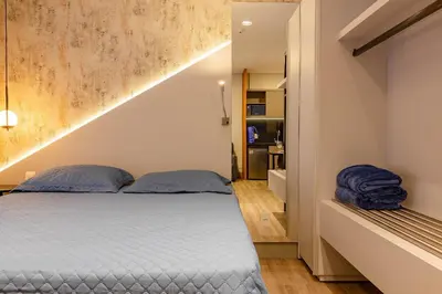 Uma cama ou camas num quarto em Confortável Loft em Condomínio com Piscina