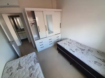 Uma cama ou camas num quarto em Apto na praia de Palmas, próximo ao mar, climatizado e com piscina