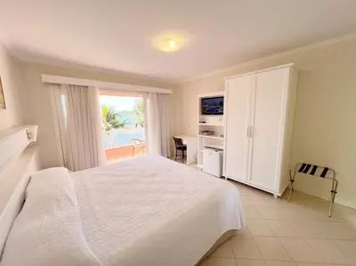 Uma cama ou camas num quarto em Pousada Vila do Coral