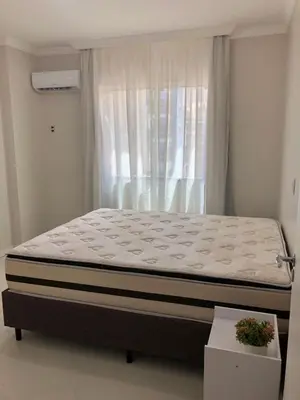 Uma cama ou camas num quarto em Apartamento de temporada rua 252 - Meia Praia - Itapema