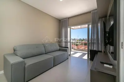 Uma televisão e/ou sistema de entretenimento em Lindo Duplex na Praia de Canto Grande com ótima localização