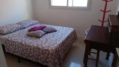 Uma cama ou camas num quarto em Apto na praia de Palmas, climatizado, com piscina, próximo ao mar e com jardim privativo