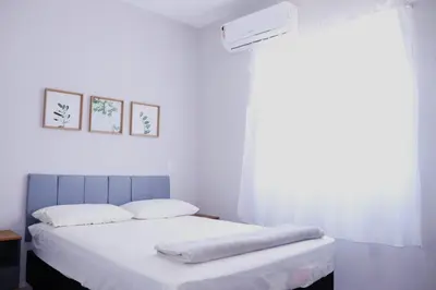 Uma cama ou camas num quarto em Enseada de Zimbros Residencial