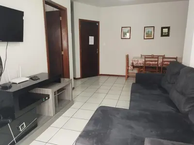 Uma televisão e/ou sistema de entretenimento em Apartamento de Praia no Centro