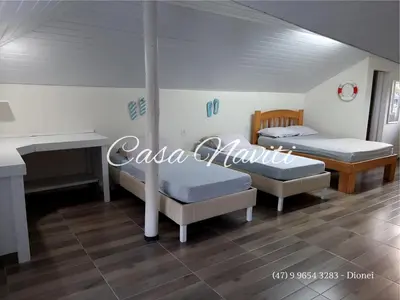 Uma cama ou camas num quarto em Casa Naviti Rua Bem Te Vi 233 Bombinhas com piscina