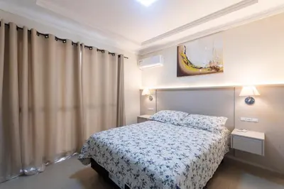 Uma cama ou camas num quarto em Bombinhas Tourist Apart
