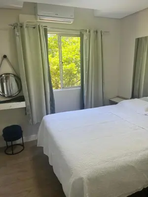 Uma cama ou camas num quarto em Aconchego azul do mar