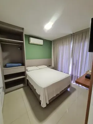 Uma cama ou camas num quarto em Residencial Bombinhas