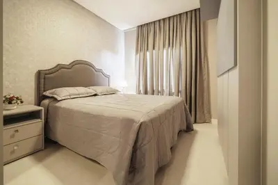 Uma cama ou camas num quarto em Apartamento 2 suítes com Piscina Centro Bombinhas