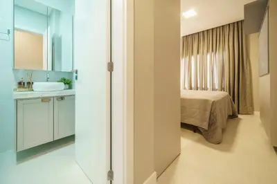 Uma cama ou camas num quarto em Apartamento 2 suítes com Piscina Centro Bombinhas