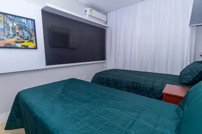 Uma televisão e/ou sistema de entretenimento em Apartamento 306B – Edifício Boulevard em Bombinhas