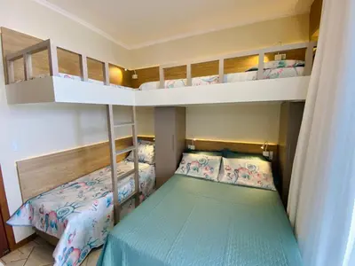 Uma cama ou camas num quarto em Apartamento Triplex Pé na Areia - Bombinhas