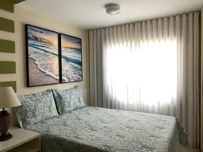 Uma cama ou camas num quarto em Apartamento Triplex Pé na Areia - Bombinhas