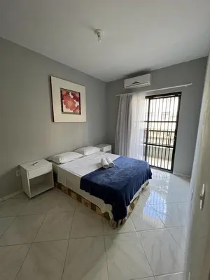 Uma cama ou camas num quarto em Dax Bombinhas