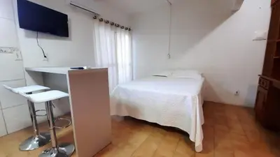 Uma cama ou camas num quarto em Loft na av. Meia Praia, Itapema