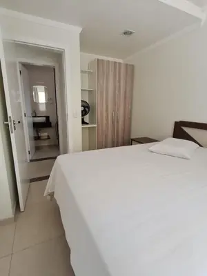 Uma cama ou camas num quarto em Residencial Costa Marfim