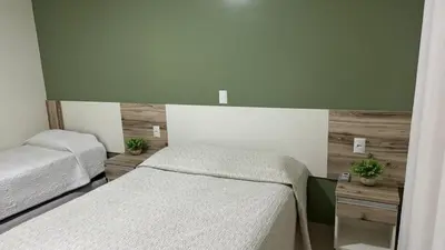 Uma cama ou camas num quarto em Residencial Costa Marfim