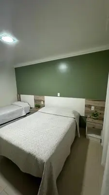 Uma cama ou camas num quarto em Residencial Costa Marfim