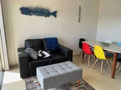 Uma área de estar em Encanto de apartamento, novo! A 290 metros da praia do Canto Grande!