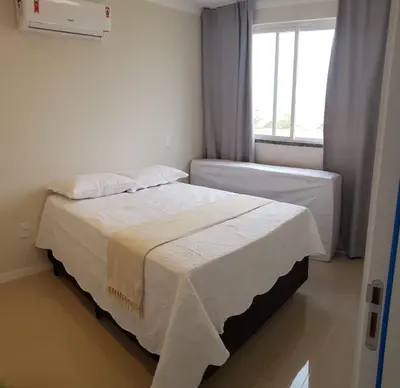 Uma cama ou camas num quarto em Apartamento de Luxo com Piscina em Bombinhas