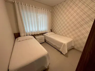 Uma cama ou camas num quarto em Costa do Marfim - Bombinhas