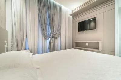 Uma cama ou camas num quarto em Aluguel Moderno Apartamento 3 quartos