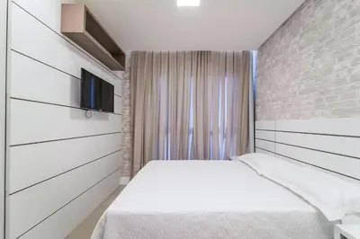 Uma cama ou camas num quarto em Aluguel Moderno Apartamento 3 quartos