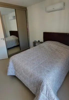 Uma cama ou camas num quarto em Amplo apto 3 suítes