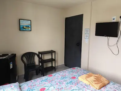 Uma televisão e/ou sistema de entretenimento em Casa de Praia Família Próximo ao ExpoCentro BC