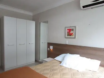 Uma cama ou camas num quarto em Bombinhas Summer Beach