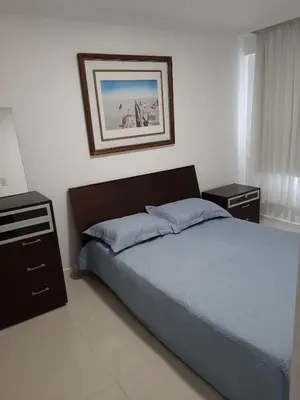 Uma cama ou camas num quarto em Meia Praia - apartamento com sacada ampla e churrasqueira, próximo a praia e a avenida principal.
